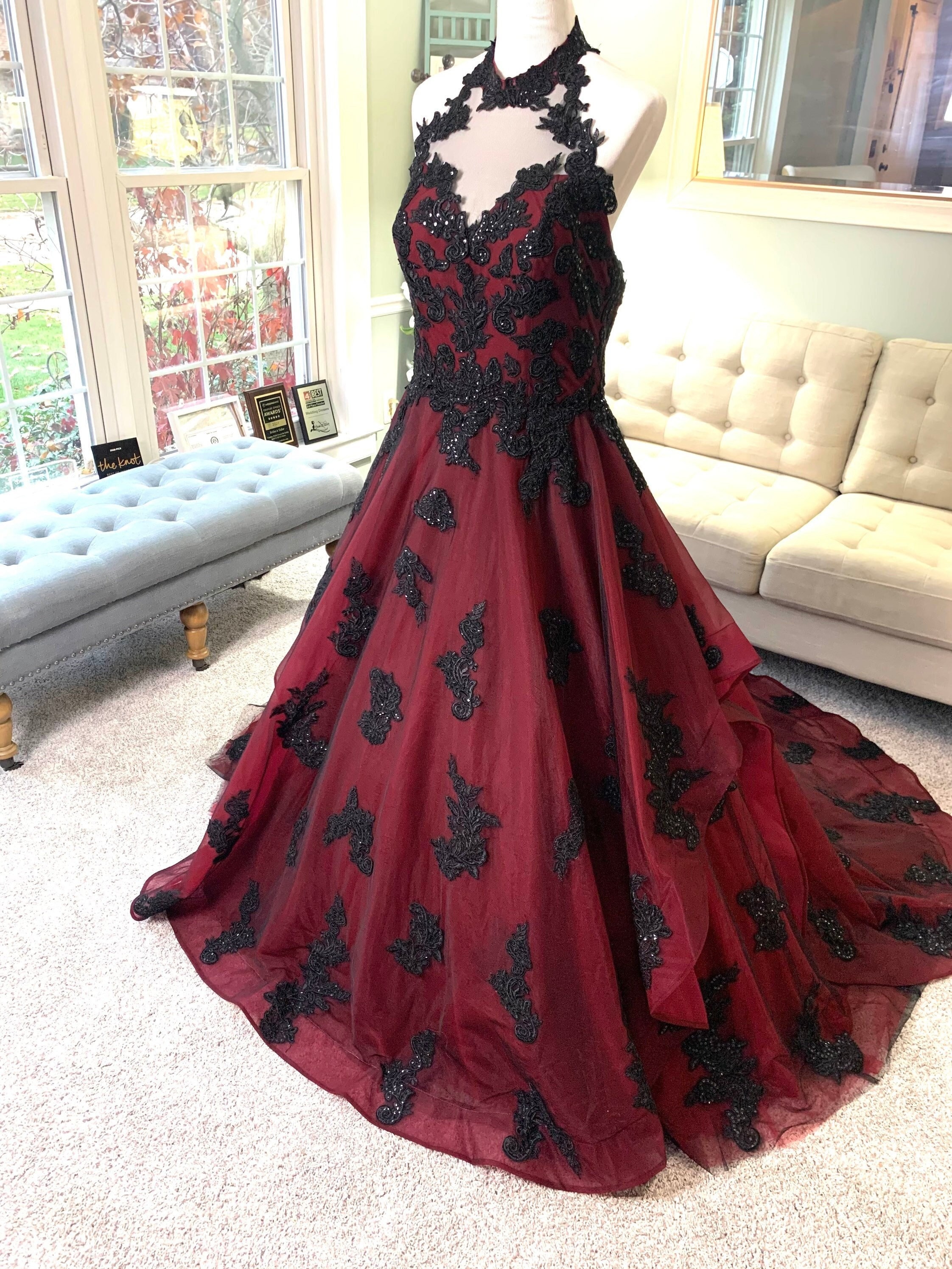 BLACK GOWN WITH RED DRAPING STYLE PATTERN