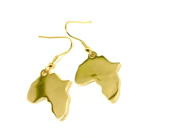 May include: Gold earrings shaped like the continent of Africa.