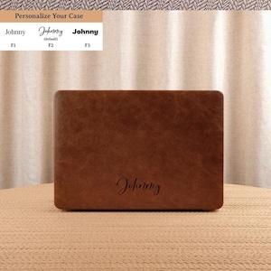 May include: A rectangular brown faux leather laptop case with a smooth, textured surface. The name Johnny is engraved in a cursive script font in the lower center. Above, a chart shows three font options labeled F1, F2, and F3.