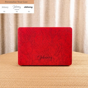 May include: A rectangular red laptop case featuring an embossed floral pattern across the entire surface. The name Johnny is printed in black script font in the lower centre. Above the case, a chart displays three font options labelled F1, F2, and F3.