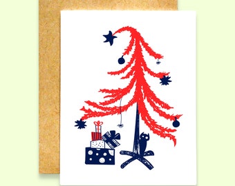 May include: A red Christmas tree with a black cat sitting under it. The tree is decorated with blue stars and red ornaments. There are wrapped presents under the tree.