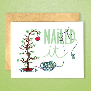 May include: A humorous Christmas card featuring a cartoon of a poorly decorated Christmas tree with tangled lights and the text "NAILED it".