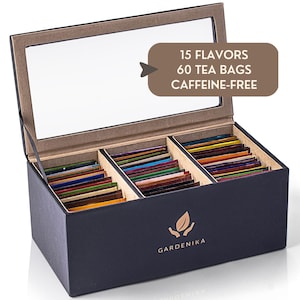 May include: A white ceramic mug with a black handle and the text "But First, Coffee" in a black, handwritten-style font. The mug is on a white surface.