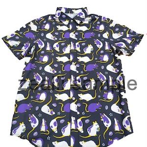 May include: Dark gray button-up shirt with a repeating pattern of white and purple cartoon mice, yellow tails, and star and oval accents. The short-sleeved shirt has a classic collar.
