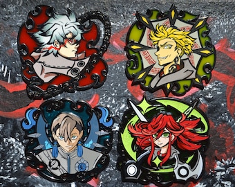 May include: Four colorful enamel pins featuring anime-style characters. Each pin has a unique design with vibrant colors, including red, green, yellow, and blue. The pins have black borders and intricate details, showcasing a variety of character expressions and styles.