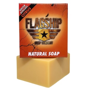 May include: A bar of natural soap in a yellow box with the text "FLAGSHIP SOAP COMPANY" and "NATURAL SOAP". The box also has a red and black label that says "HIPSTER REPELLENT CITRUS".