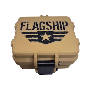 May include: A tan plastic storage case with a black strap and a black and white logo that says "FLAGSHIP" with a star and wings.