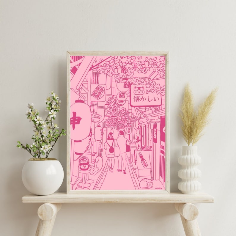 K&ouml;nnte beinhalten: Eine rosa Linienzeichnung einer japanischen Stra&szlig;enszene mit Kirschbl&uuml;ten, Laternen und Menschen, die gehen. Der Text auf einem Schild lautet "猫がほしい".