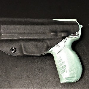 May include: A black leather holster with a screw on the side, holding a light green plastic gun.