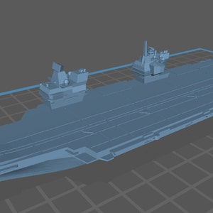 May include: A gray model of an aircraft carrier with a long, flat deck and a small island structure at the front. The carrier has a slight upward curve at the bow.