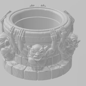May include: A white ceramic well with four gargoyle figures holding onto the rim. The well is designed to hold items like dice or other small objects.
