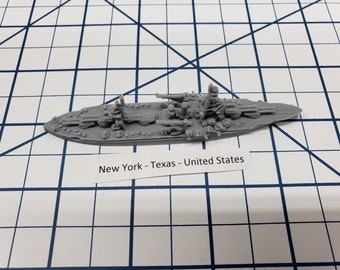 May include: A gray model of the USS Texas, a New York-class battleship, with the text "New York - Texas - United States" printed below.
