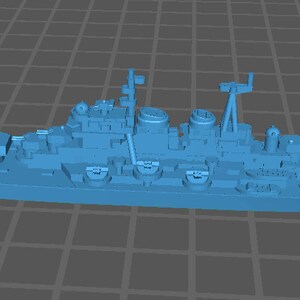 May include: A blue model of a large warship with multiple gun turrets and a long, narrow hull.