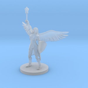 May include: White plastic miniature figurine of an angel warrior holding a staff and shield. The angel has wings and is standing on a round base.