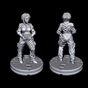 May include: A gray painted miniature figurine of a woman wearing a jumpsuit and holding a helmet. The figurine is standing on a round base.