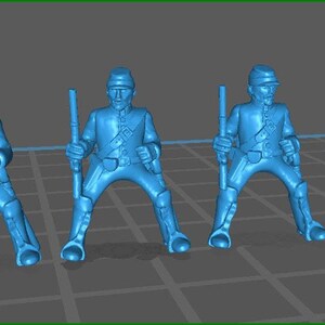 May include: Four blue plastic toy soldiers in different poses, including standing at attention, holding a rifle, and aiming a rifle. The soldiers are wearing hats and have detailed facial features.