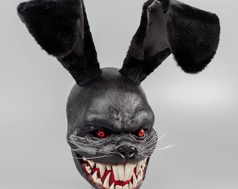 Scary rabbit mask in black with red eyes.