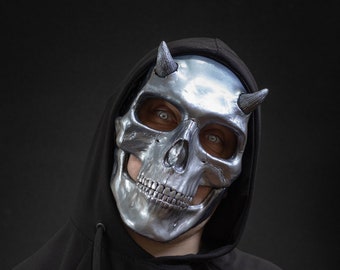 Human skull mask with small horns in glossy silver color