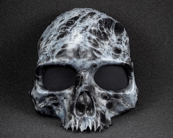 Skull mask with broken teeth and marble shape