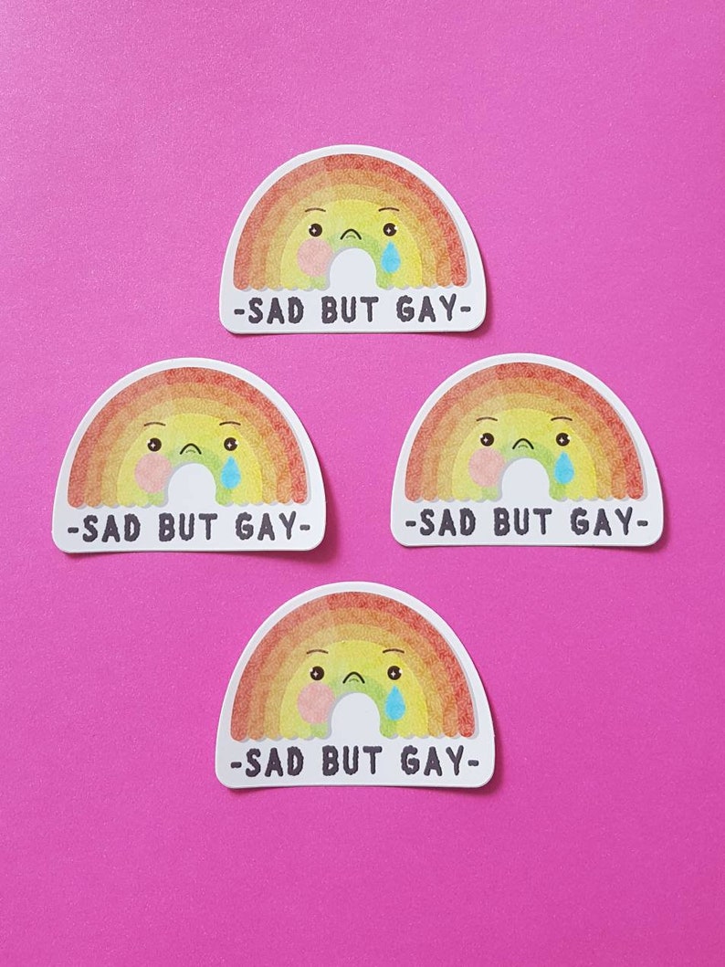 May include: Four rainbow stickers with a sad cartoon face and the text "Sad but Gay" on each.