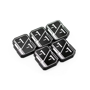 May include: A set of five rectangular black tokens with white beveled edges. Each token features a diagonal white line dividing the surface, with the text -1 printed in white on both sides of the divider, creating a consistent gaming accessory.