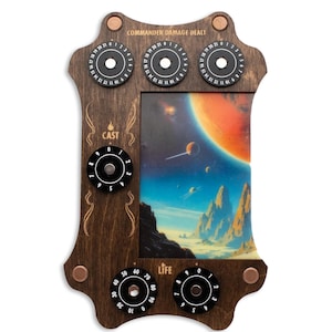 May include: Wooden game accessory with dials for tracking life, cast, and commander damage. The frame is dark brown with copper-coloured rivets. The centre features a colourful space-themed image.