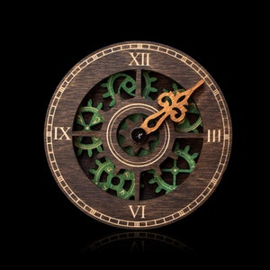 May include: A wooden clock face with Roman numerals and green gears. The clock hands are made of wood and point to the number three.