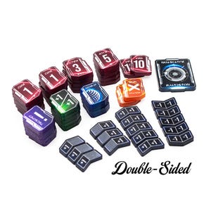 May include: A collection of rectangular game tokens in various colours including red, purple, green, blue, and orange, featuring numerical values like 1, 3, 5, 10, and plus or minus one. Some tokens are stacked, and others are arranged in rows.