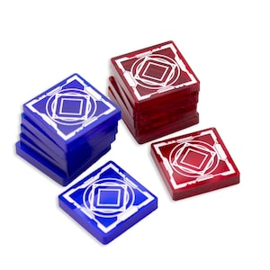 May include: Square game pieces in red and blue. Each piece has a white geometric design in the center. The pieces are stacked in piles and scattered on a white background. The pieces appear to be made of a translucent material.