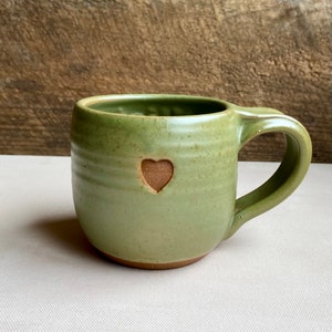 Mug in solid moss glaze.  Text on front of mug with Heart stamp on the opposite side.