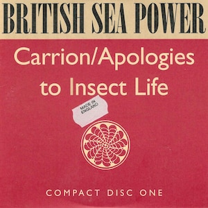 May include: A compact disc with a red background featuring the text "BRITISH SEA POWER" at the top. The title "Carrion/Apologies to Insect Life" is in the center. A sticker reads "MADE IN ENGLAND". The bottom reads "COMPACT DISC ONE".