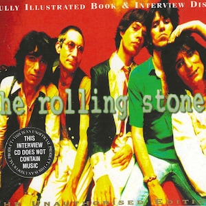 May include: A book and CD set featuring a photo of the Rolling Stones band members. The cover is red with the band's name in green and white letters. The text "FULLY ILLUSTRATED BOOK & INTERVIEW DISC" is at the top of the cover. The text "THIS INTERVIEW CD DOES NOT CONTAIN MUSIC" is in a circle on the bottom left of the cover.