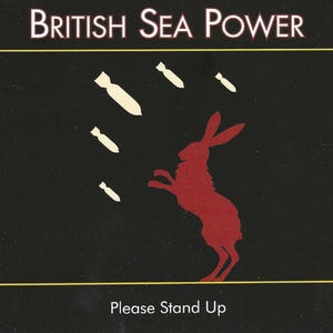 May include: A black background with the text "British Sea Power" above a red silhouette of a rabbit standing on its hind legs. White bomb shapes are falling from above. The text "Please Stand Up" is at the bottom.