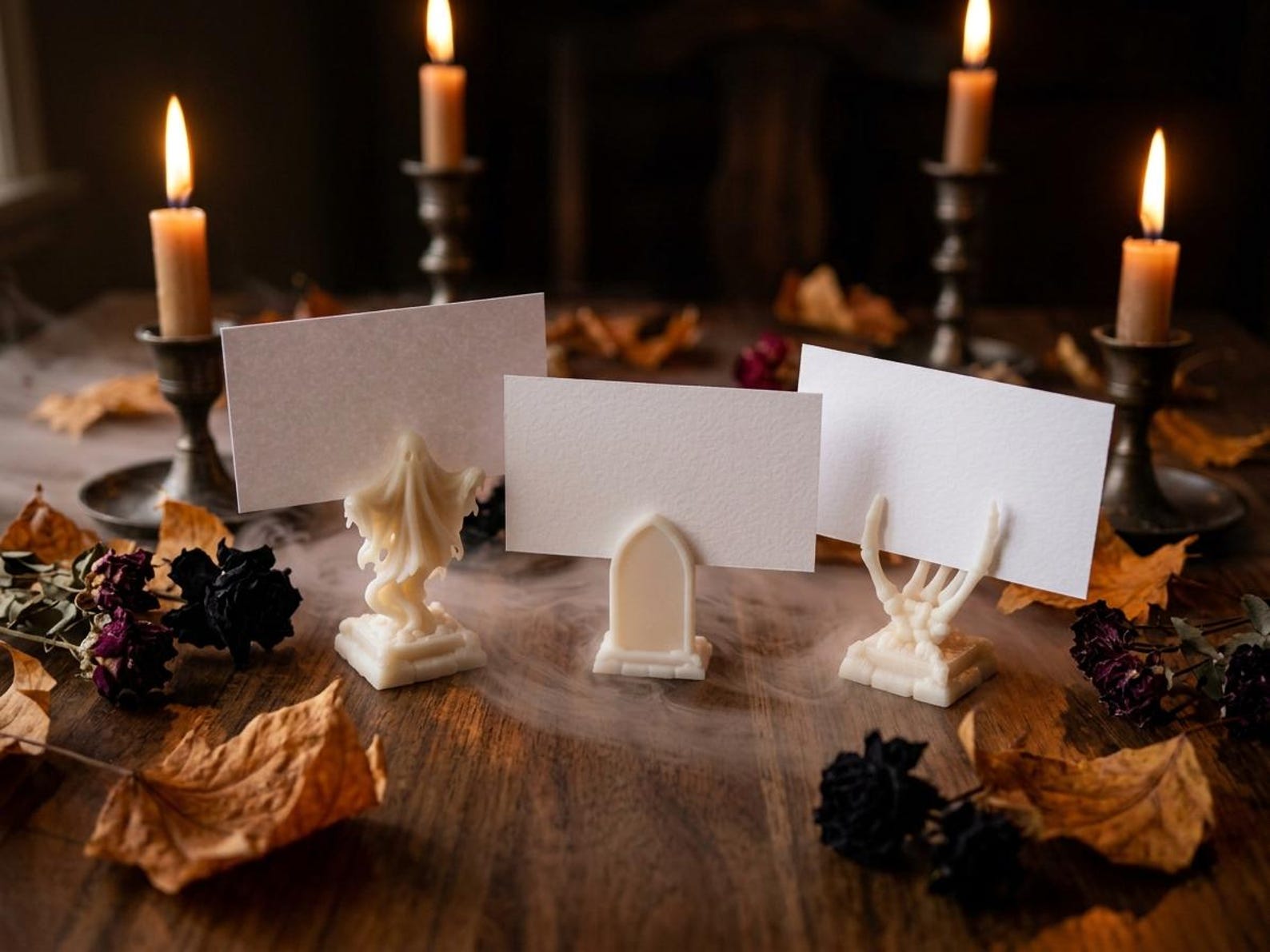 A Little Ghost Holding a Plain Card Halloween place-card display using small ghost, tombstone and skeleton-hand holders.