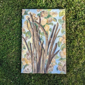 May include: A painting depicting a tree with brown branches and white flowers against a blue sky background.