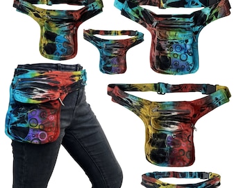 May include: A multi-colored tie-dye fanny pack with a peace sign and circle design. The pack has multiple pockets and a zipper closure. The pack is shown on a person wearing jeans.