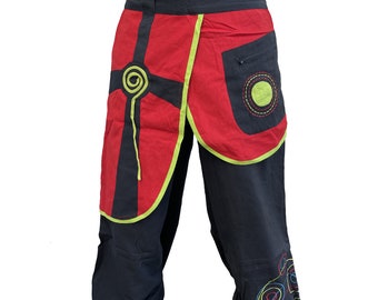 May include: Black and red pants with a green and yellow design. The pants have a pocket on the right side and a decorative design on the left side.