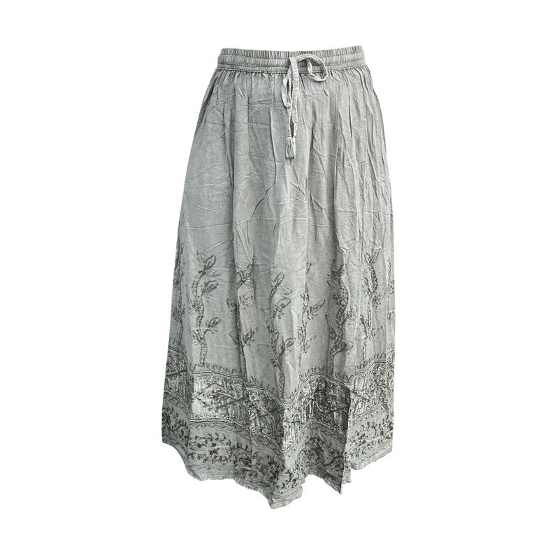 May include: A light gray, flowing skirt with a drawstring waist. The skirt features a detailed, dark gray floral and architectural pattern along the bottom and vertical floral designs. The fabric appears to be lightweight and slightly textured.