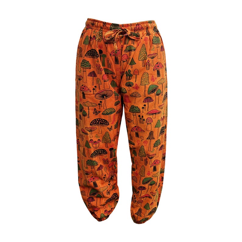 May include: Orange trousers with a mushroom print. The trousers have an elastic waistband and a drawstring.