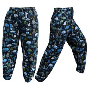 May include: Black trousers with a blue and white mushroom print. The trousers have an elastic waistband and a drawstring.