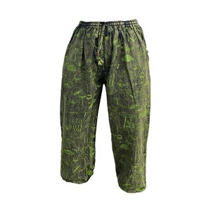 May include: Green trousers with a mushroom print. The trousers have a drawstring waist and a relaxed fit.