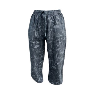 May include: Black cotton trousers with a white mushroom print.