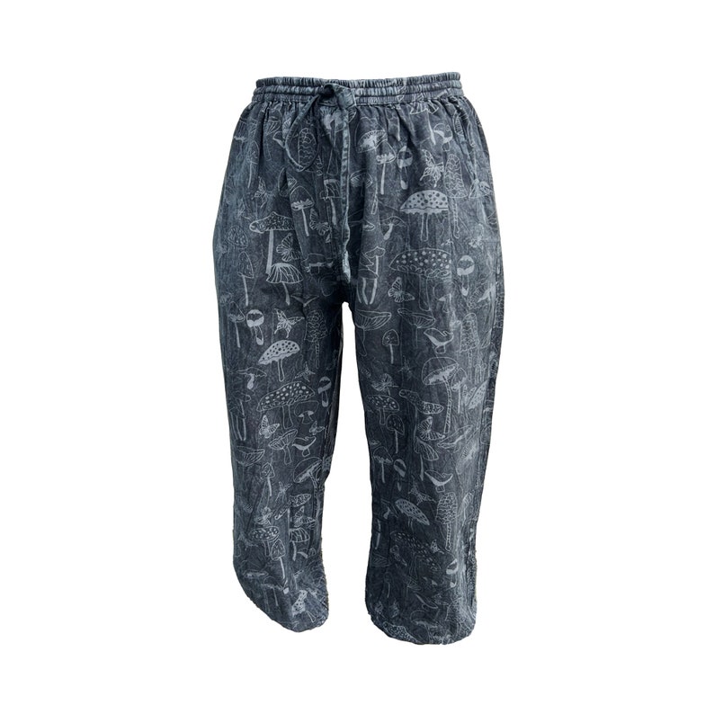 May include: Black cotton trousers with a white mushroom print.