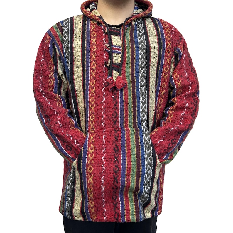 May include: A red, white, blue, and green striped hooded sweater with a drawstring. The sweater has a geometric pattern and a pouch pocket.