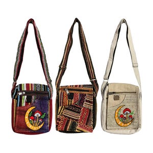May include: Three colorful crossbody bags with adjustable straps. The bags feature a variety of patterns and textures, including patchwork and embroidered designs. Each bag has a front pocket with a zipper and a unique embroidered design of a crescent moon and mushrooms.