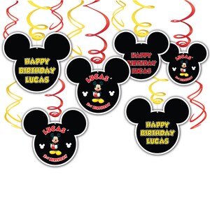 May include: Five black and yellow Mickey Mouse head shaped party decorations with the text "Happy Birthday Lucas" and a Mickey Mouse character with the text "2nd Birthday".