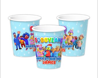 May include: Three blue and white paper cups with a Doggyland theme. The cups feature a group of cartoon dogs and the text "Happy 3rd Birthday James".