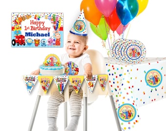 May include: A colourful first birthday party set featuring a banner, cake topper, plates, tablecloth, and a hat. The banner says "My First Birthday" and the tablecloth has a polka dot pattern. The cake topper has a number one and the plates have a cartoon character on them. The hat is blue and white with a number one on it.