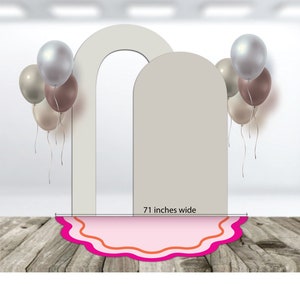 May include: Two white arches with a pink and orange scalloped rug in front. The arches are 71 inches wide. There are several balloons in the background, including silver, brown, and beige.
