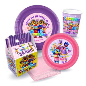 May include: A set of party supplies featuring the characters from the children's show "Doggyland". The set includes a pink and purple paper plate, a pink and purple paper cup, a pink and purple paper napkin, and a purple and yellow favor box. The plates and cups feature the characters from the show, and the favor box has the show's logo and the text "Happy 3rd Birthday Ja'Kai".